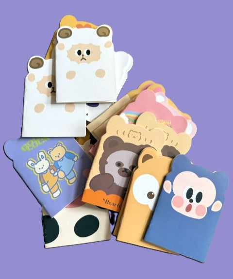 Kawaii animal mini notepads with die-cut bear, bunny, and monkey covers on purple background