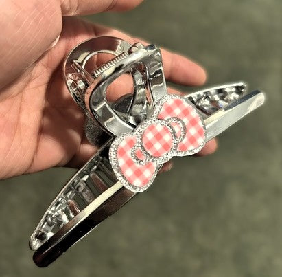 Hello Kitty silver claw clip showing pink gingham bow detail