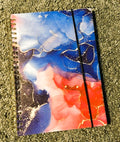 Blue cosmos marble ink spiral notebook with red and navy tones