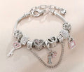 Silver charm bracelet with crystal charms on neutral background