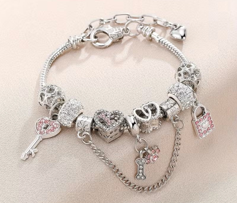 Silver charm bracelet with crystal charms on neutral background