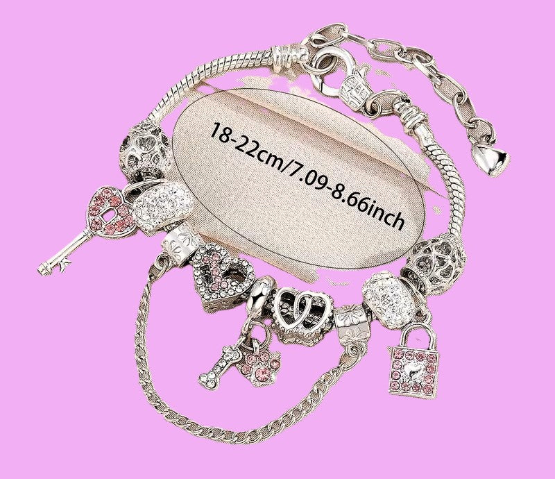 Silver charm bracelet showing adjustable length 18-22cm on pink background