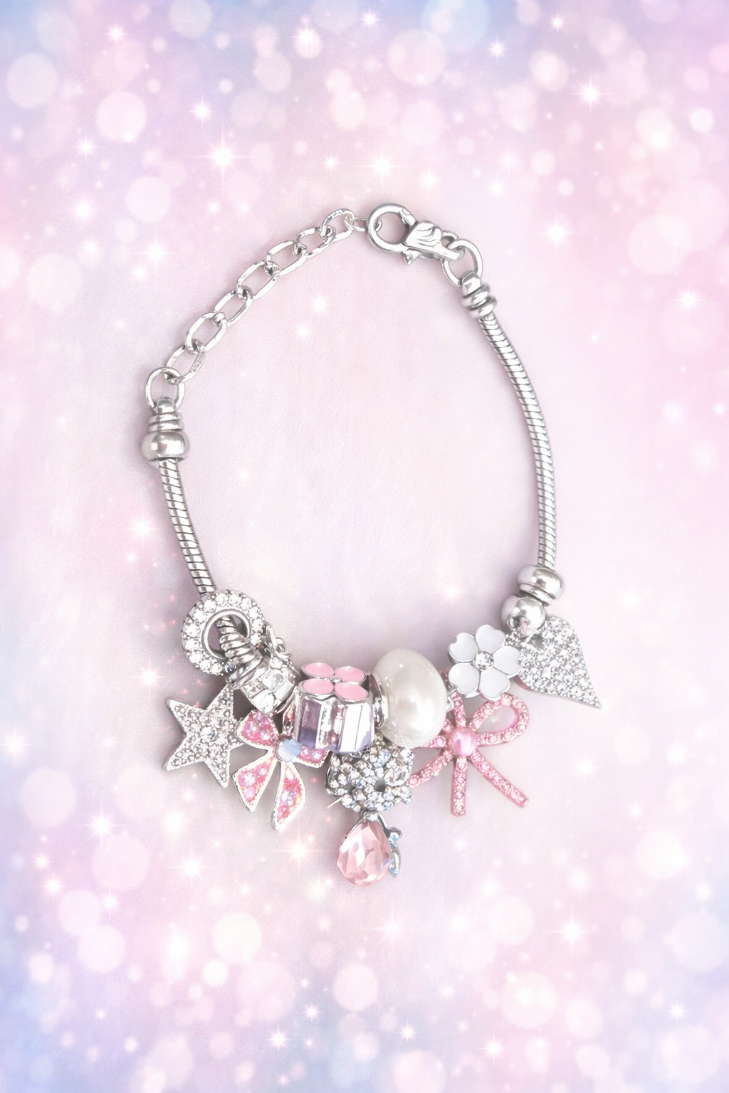 Kawaii pink charm bracelet with star, bow, pearl and crystal charms on silver snake chain
